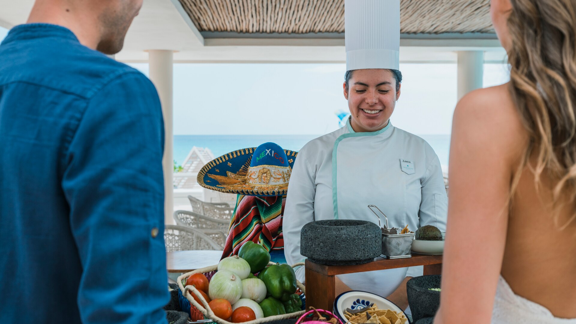 a group of people preparing food on a table