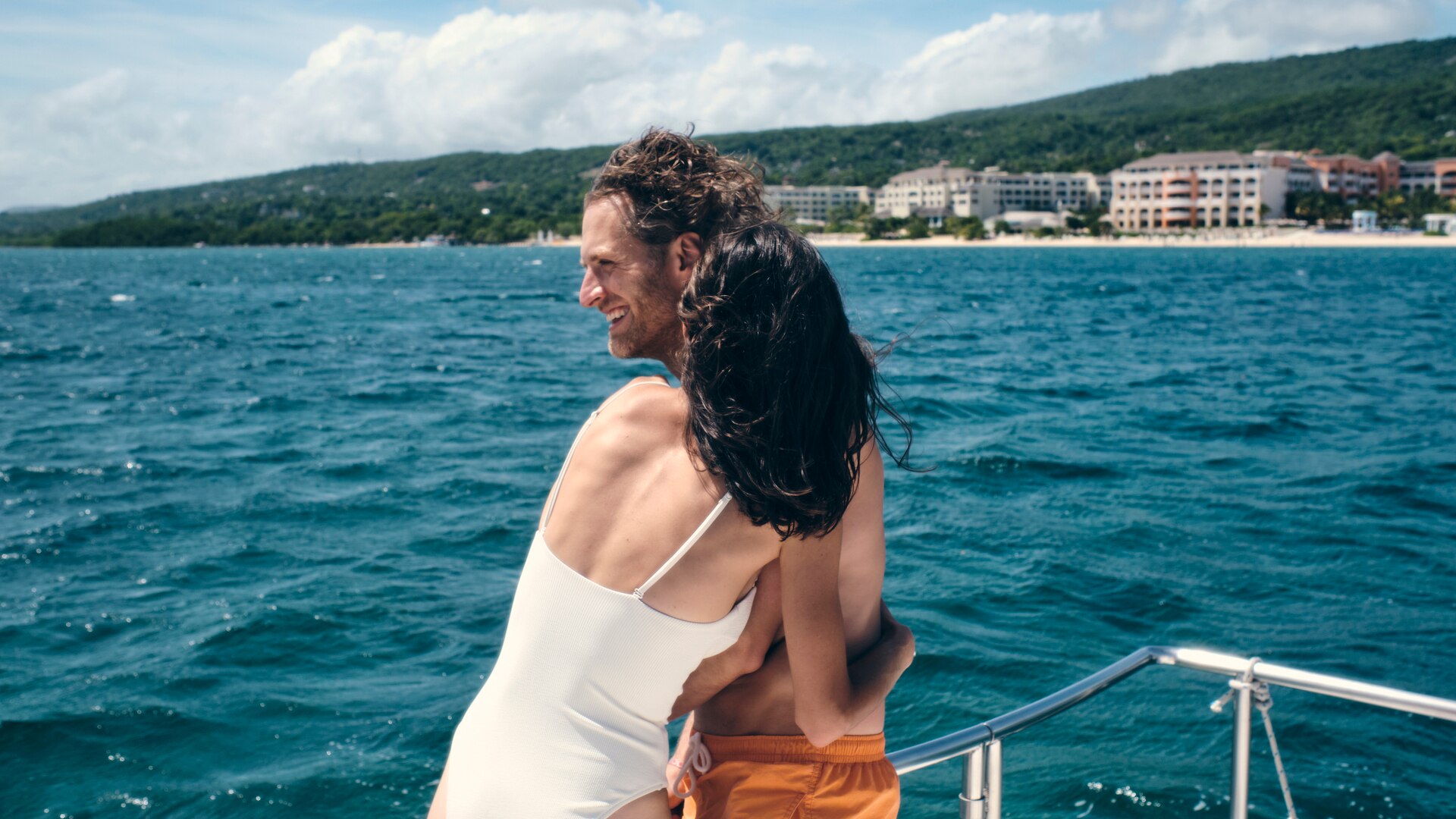 a woman sitting at a table with a vase of flowers