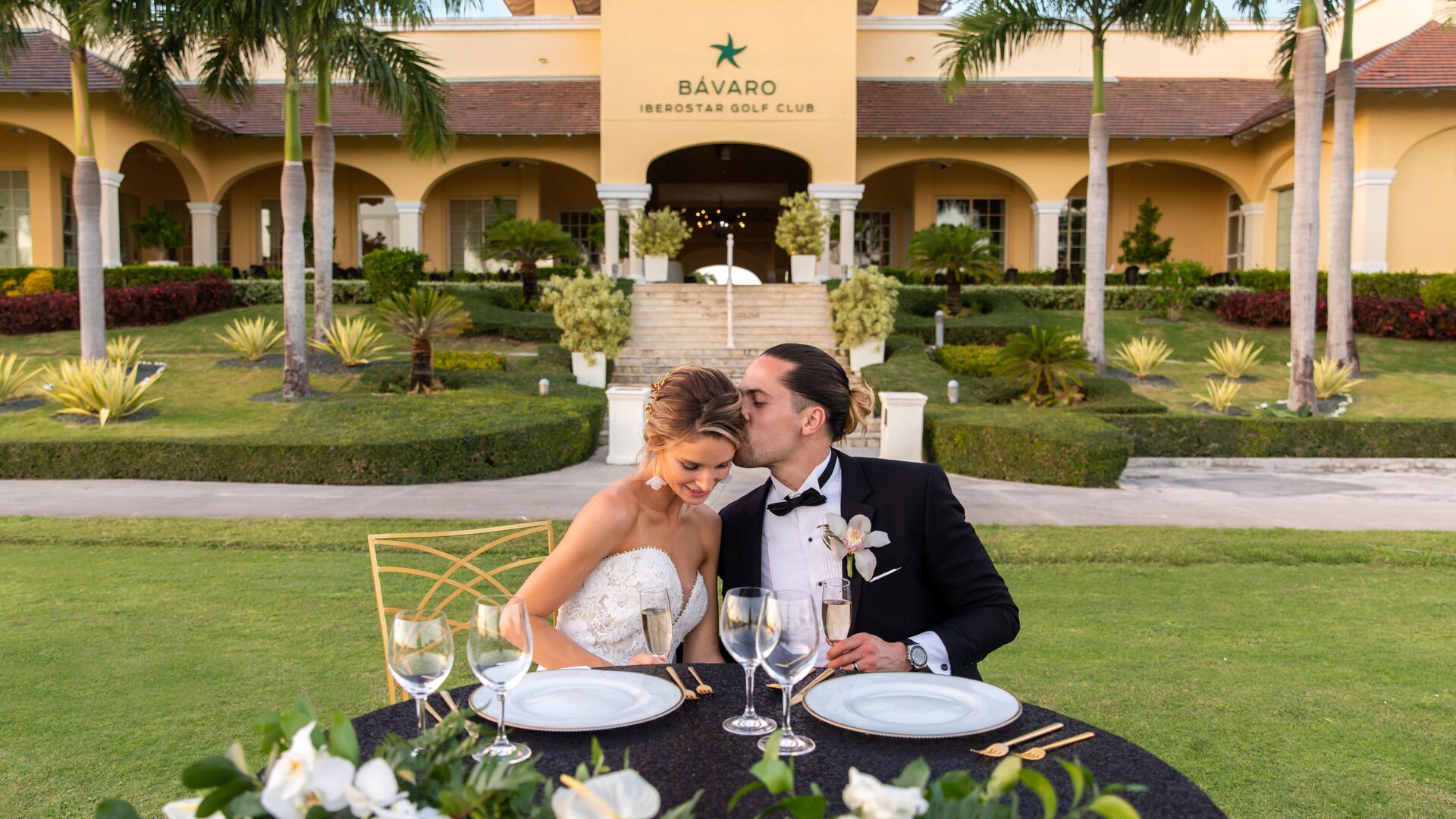 a person sitting at a table in front of a building