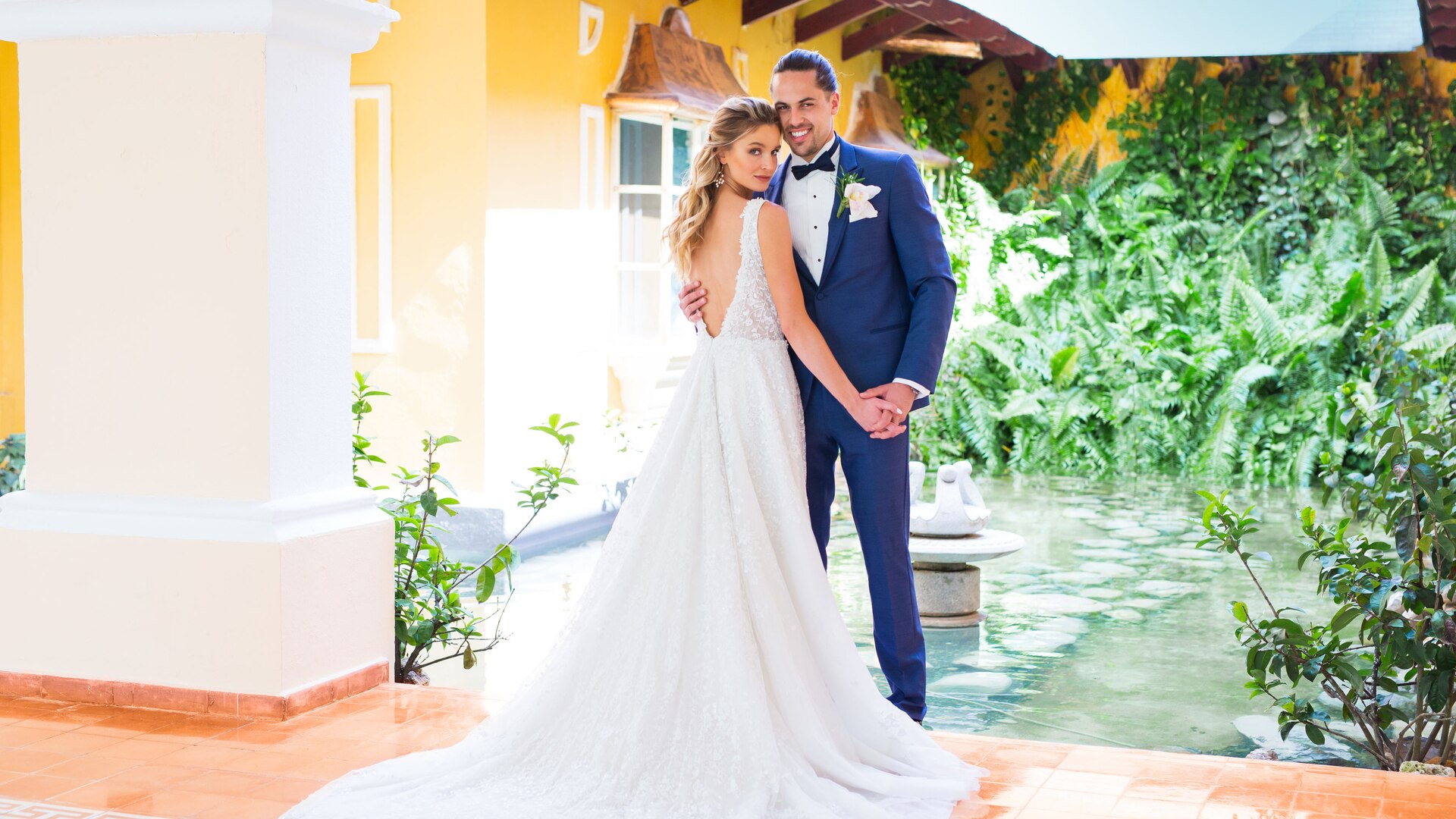 a person standing in front of a wedding cake