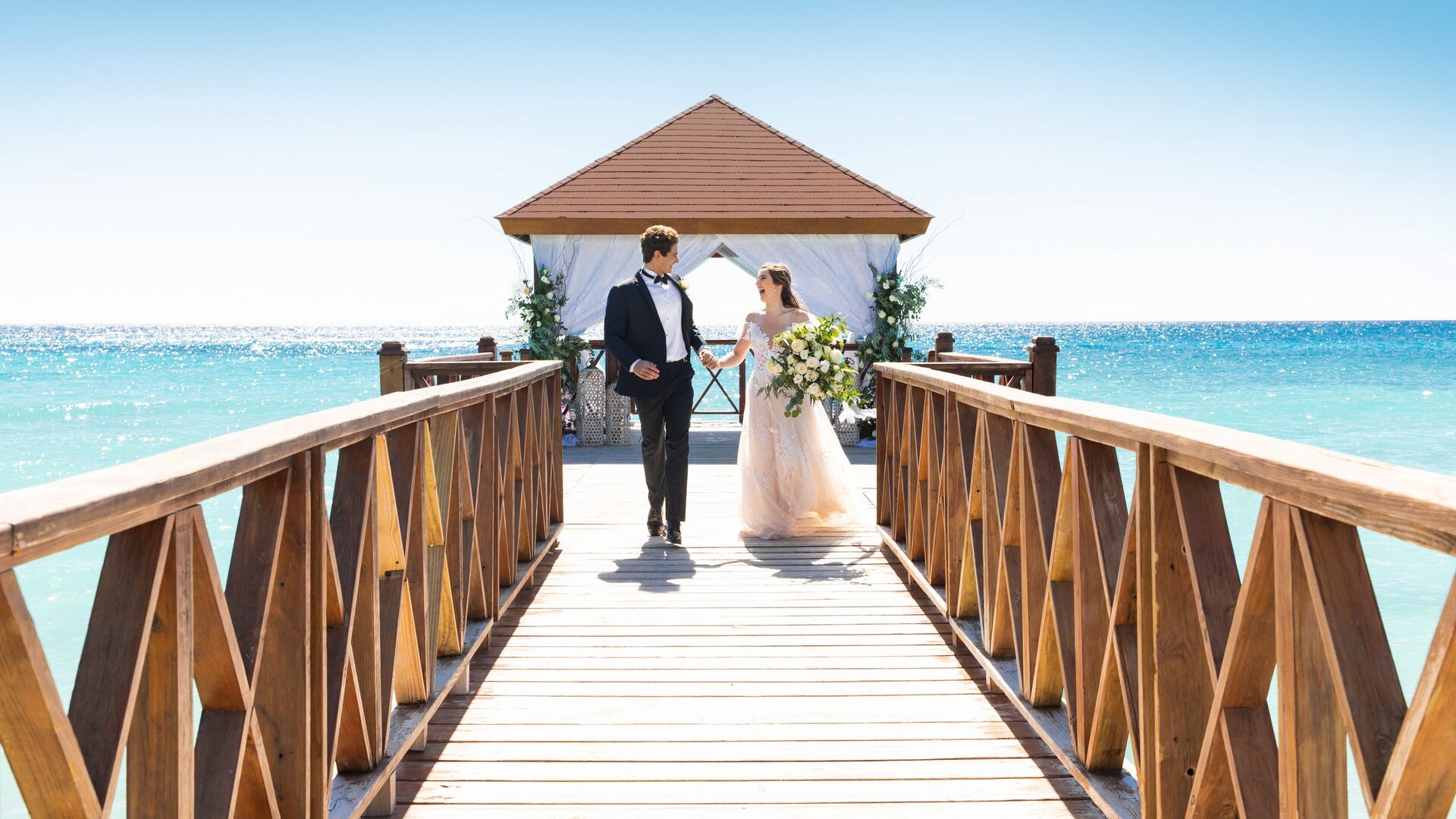 a wooden pier next to a body of water