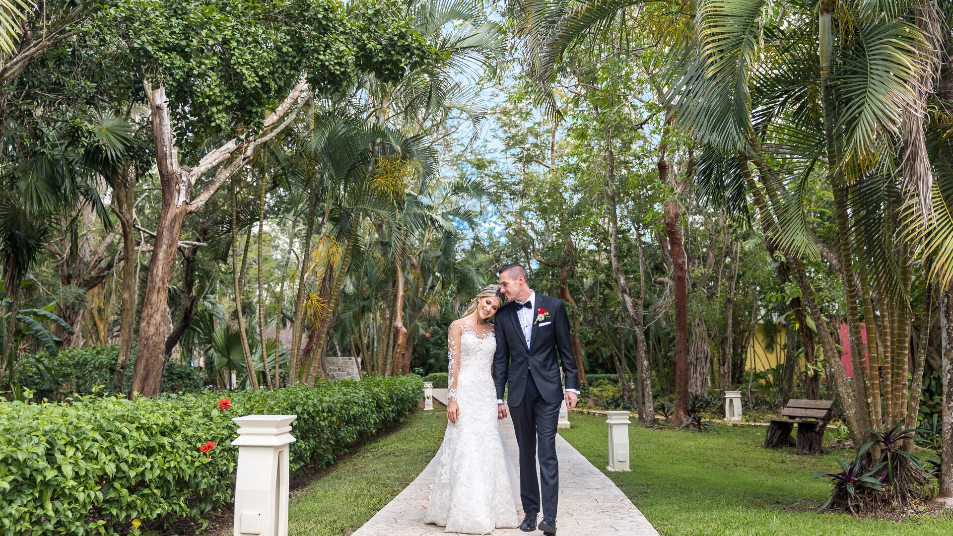 a person standing next to a palm tree