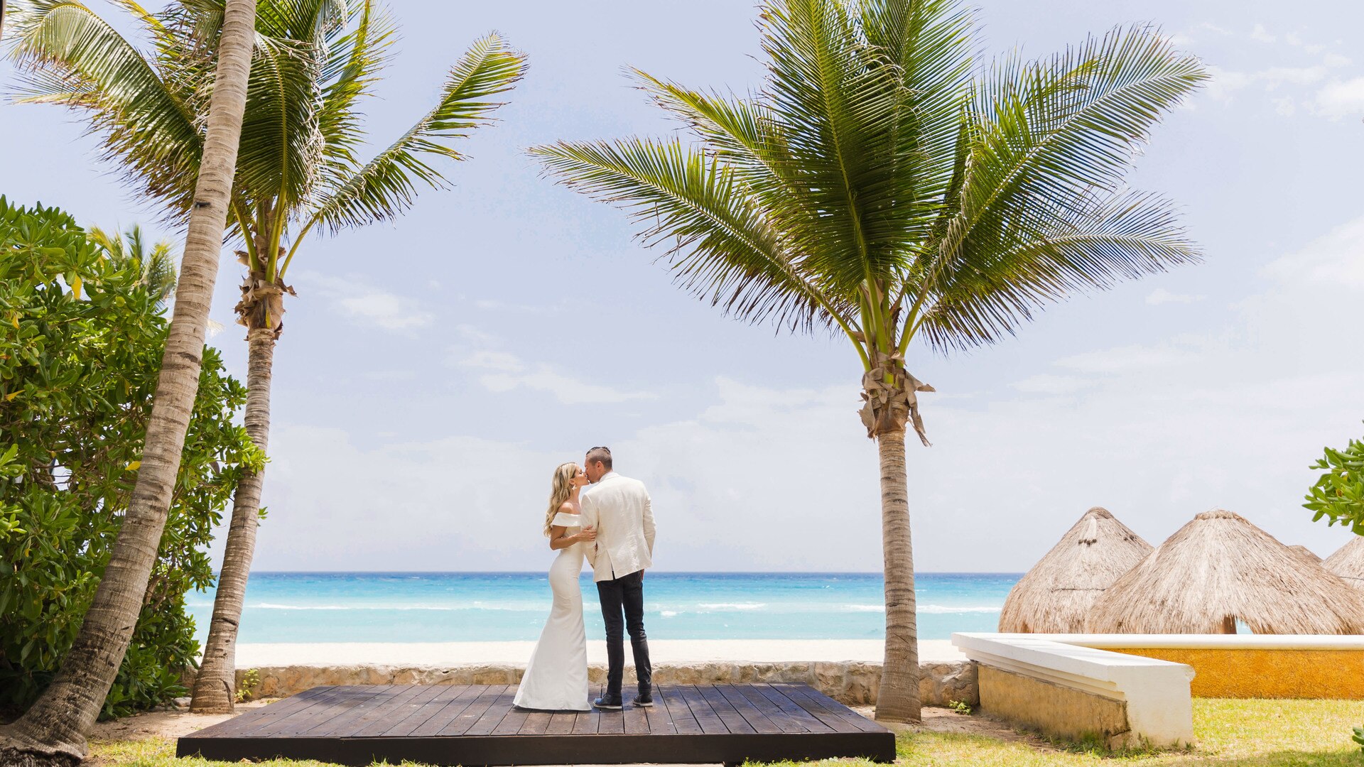a group of people on a beach with a palm tree