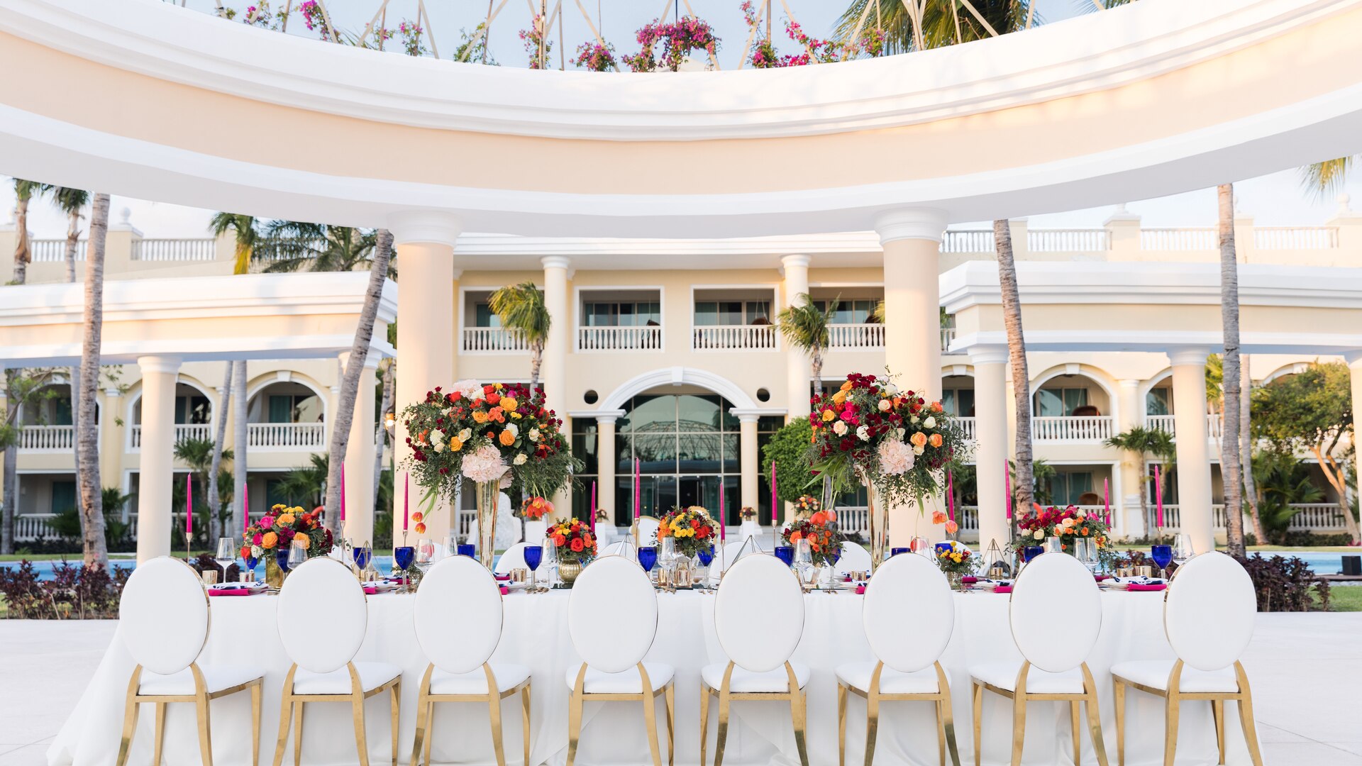 a group of people sitting at a table in front of a building