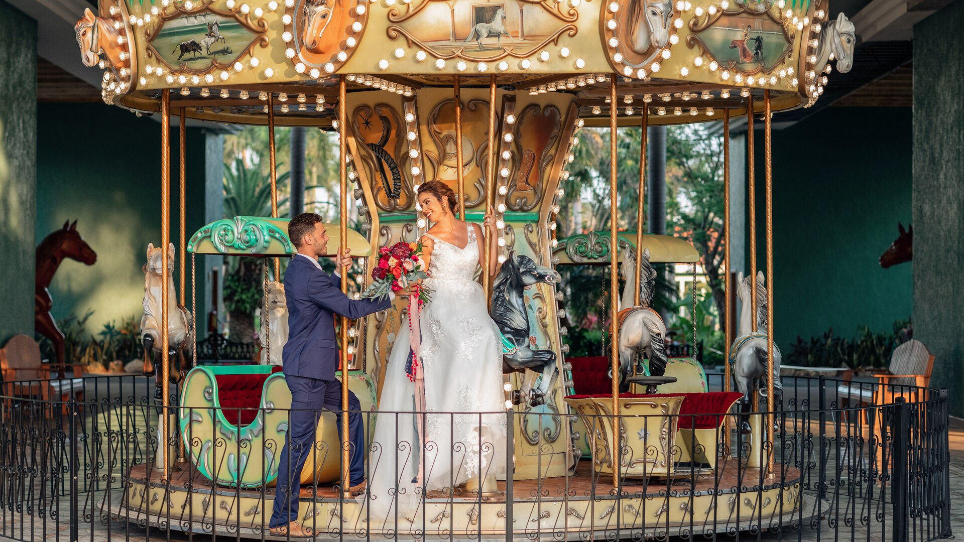 a group of people standing in front of a carousel