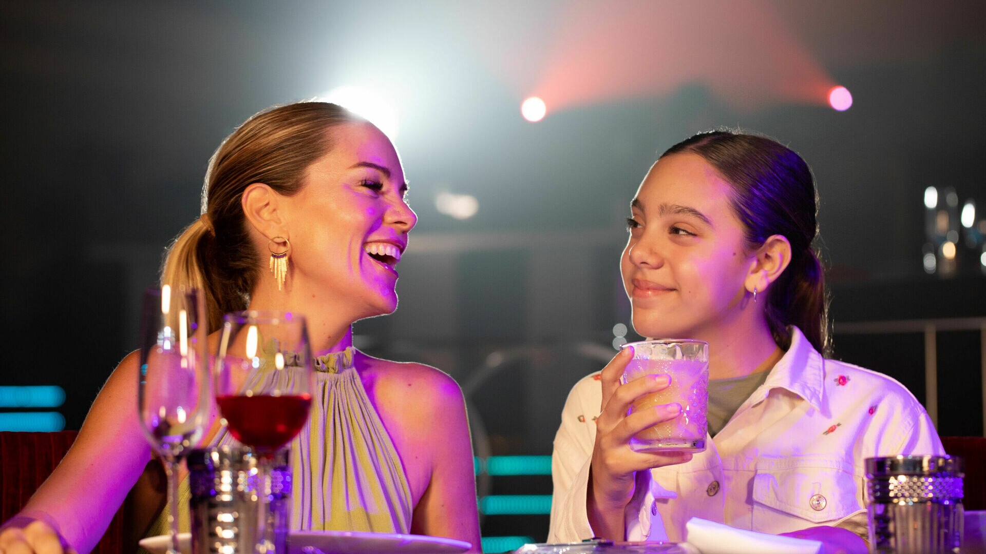 a man and a woman sitting at a table with wine glasses