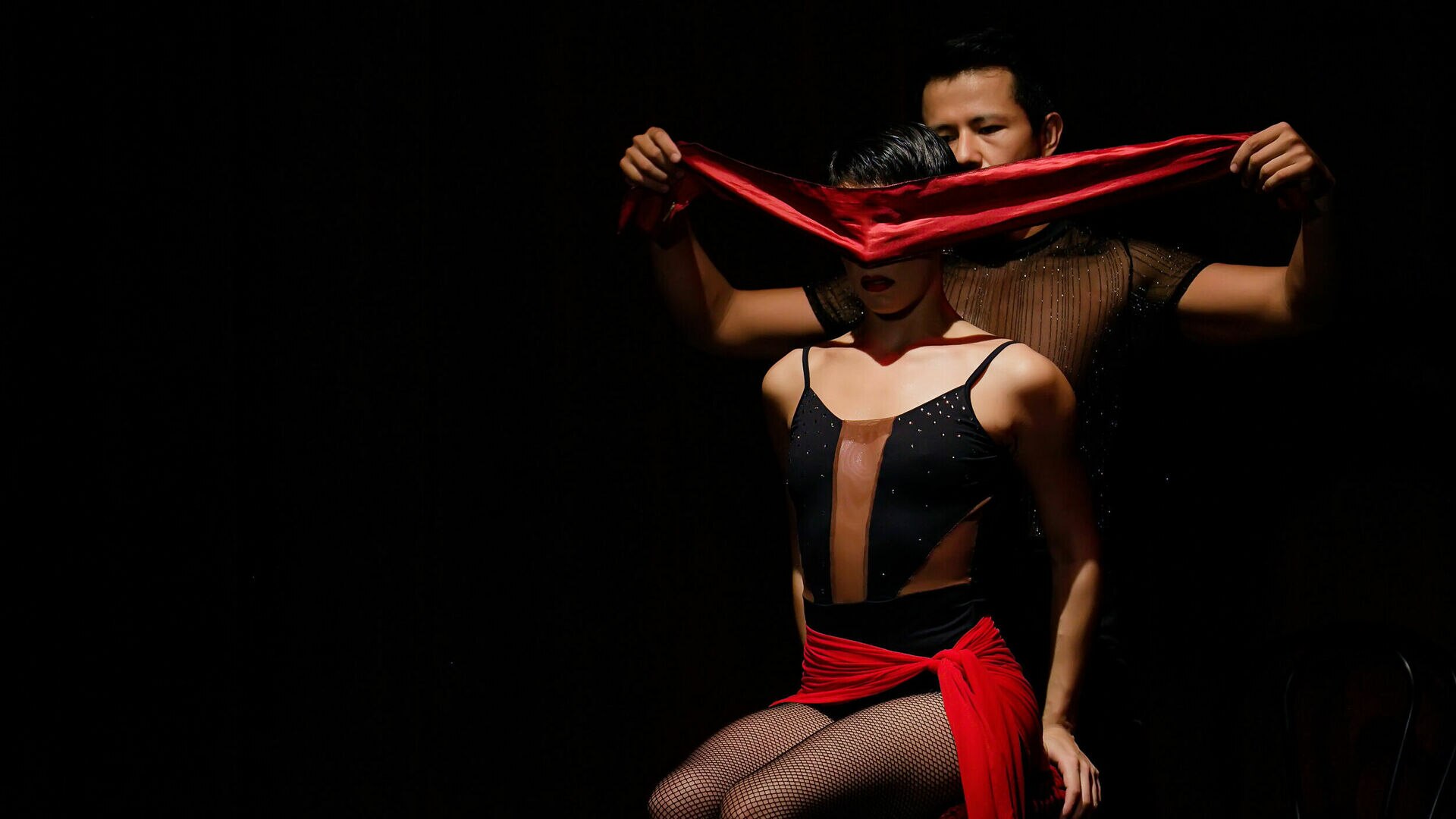 a woman sitting in a dark room