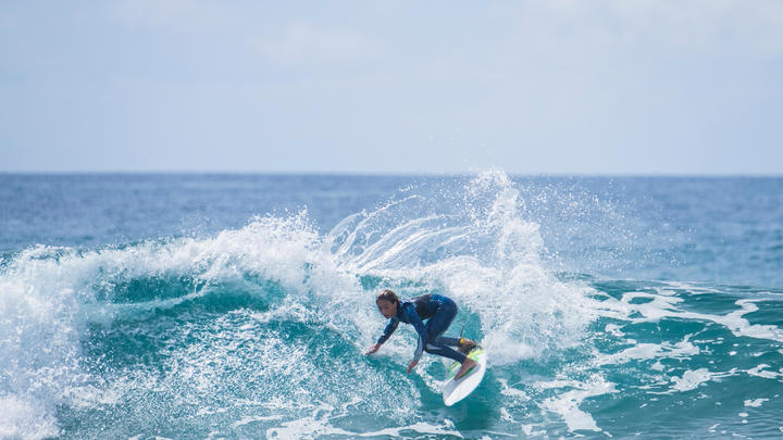 a man riding a wave on a surfboard in the ocean