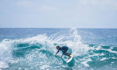 a man riding a wave on a surfboard in the ocean