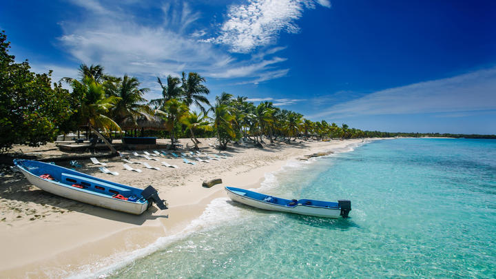 a person lying on a sandy beach next to a body of water