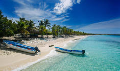 a person lying on a sandy beach next to a body of water