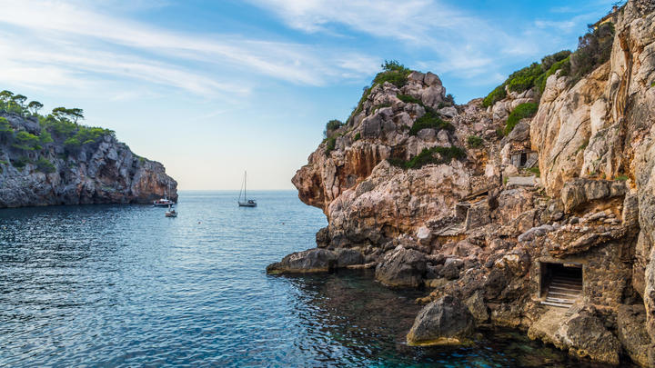 a rocky island in the middle of a body of water