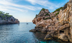 a rocky island in the middle of a body of water