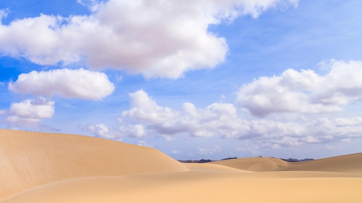 a group of clouds in the sand