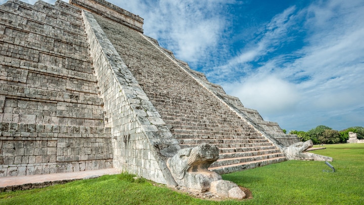 a stone building that has a large rock