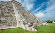 a stone building that has a large rock