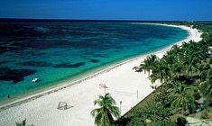 a sandy beach next to a body of water