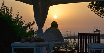 a man standing in front of a sunset