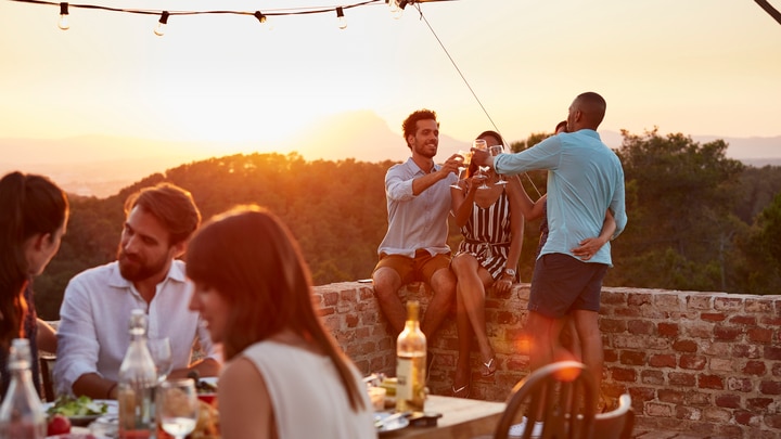 a group of people standing around a table