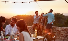 a group of people standing around a table