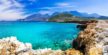 a body of water with a mountain in the background