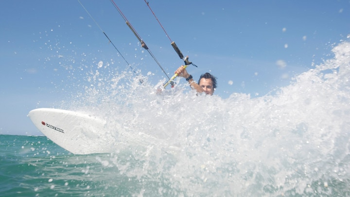 a man riding a wave on a surfboard in the ocean