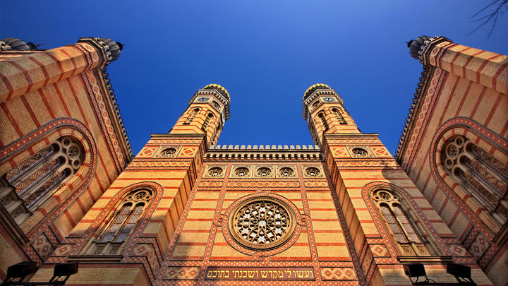 a large tall tower with a clock at the top of a building