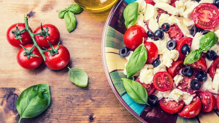 a plate of fresh fruit and vegetables on a table