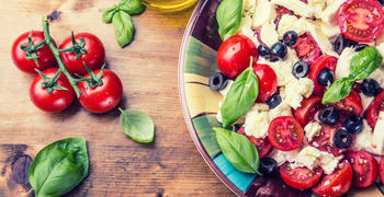 a plate of fresh fruit and vegetables on a table