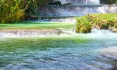 a large waterfall over some water