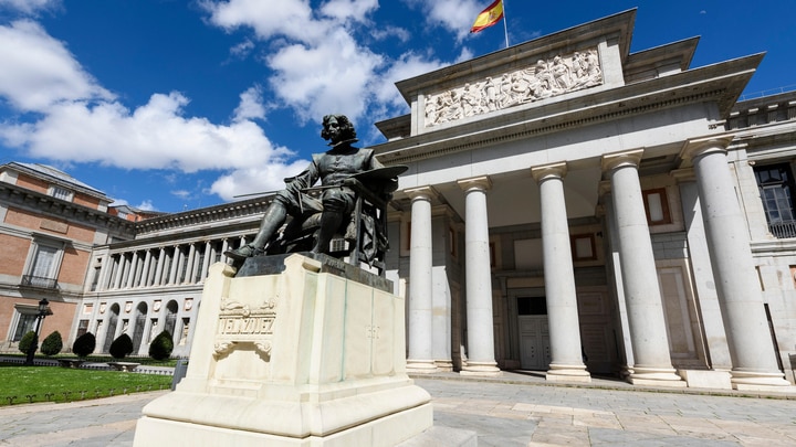 a large stone statue in front of Museo del Prado