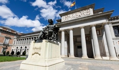 a large stone statue in front of Museo del Prado