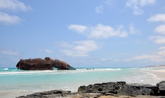 a rocky beach next to the ocean