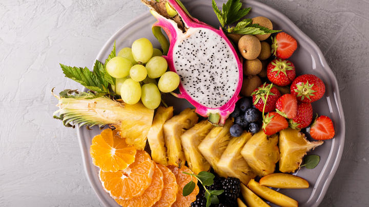 a plate of fruit and vegetable stand