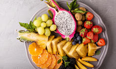 a plate of fruit and vegetable stand