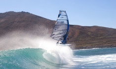 a man flying through the air while riding a wave