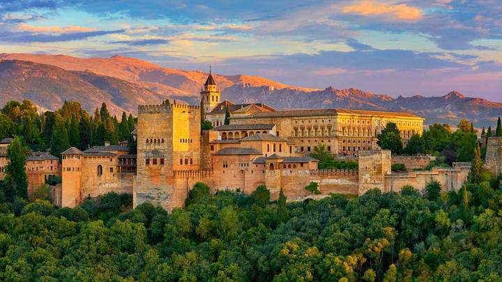 a castle like building with a mountain in the background