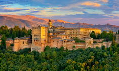 a castle like building with a mountain in the background