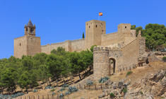 a stone castle next to a brick building