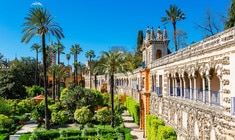 a castle with a clock tower in a garden