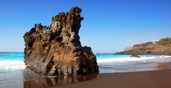 a man standing next to a body of water