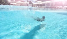 a man swimming in a pool of water