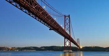 a train crossing a bridge over a body of water