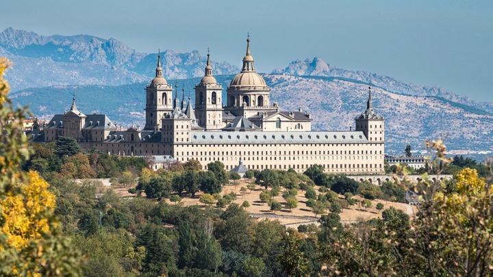 a castle like building with a mountain in the background