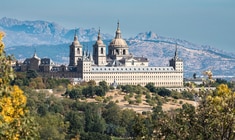 a castle like building with a mountain in the background