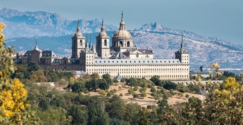 a castle like building with a mountain in the background