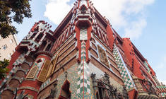 a large brick building with Casa Vicens in the background