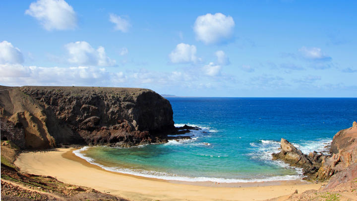 a rocky beach next to the ocean