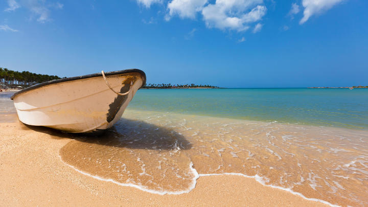 a boat sitting on top of a beach