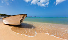 a boat sitting on top of a beach